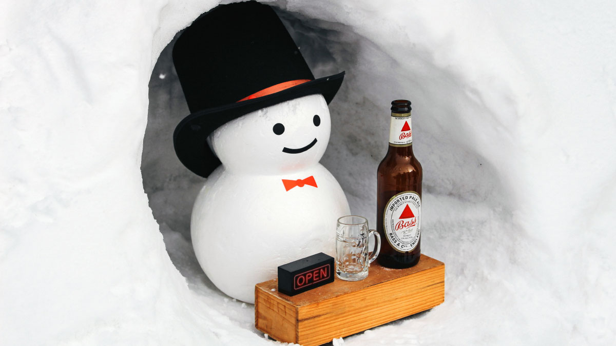 un pupazzo di neve serve la birra nella neve