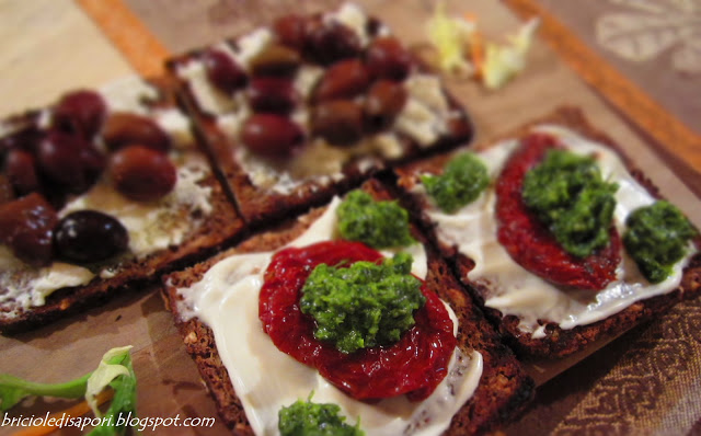 Crostini di segale con olive, salsa verde e pomodorini sott'olio